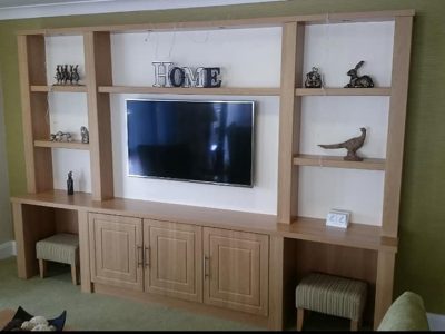 tv installed into modern brown alcove